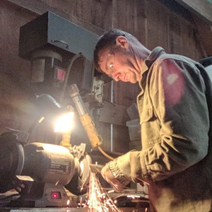 man sharpening a knife